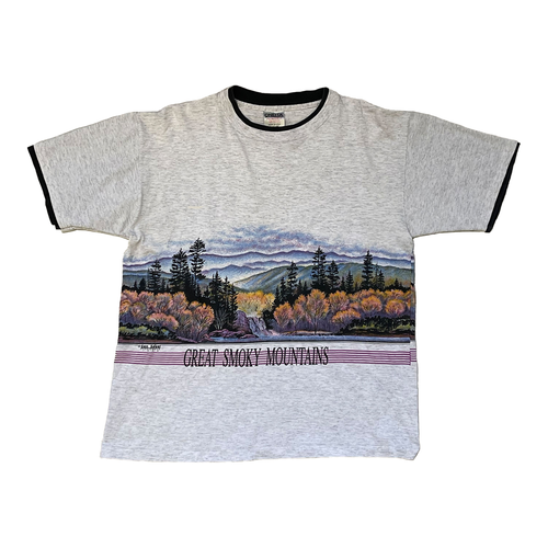 heather grey short sleeve shirt of grey smoky mountains that continues all around the entire shirt. lettering bellow image says great smoky mountains. shirt is double layer with black as the fabric.