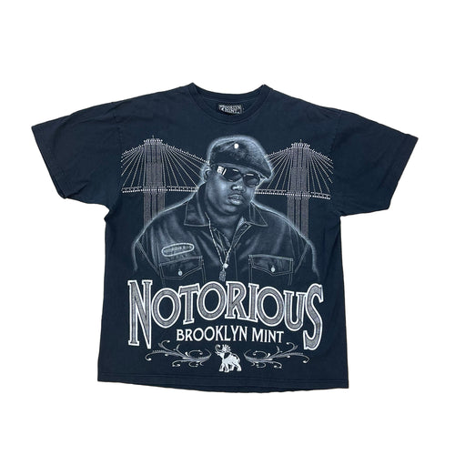 BLACK NOTORIOUS BROOKLYN MINT SHIRT. BIGGIE ON THE FRONT WITH BROOKLYN BRIDGE IN THE BACK GROUND.