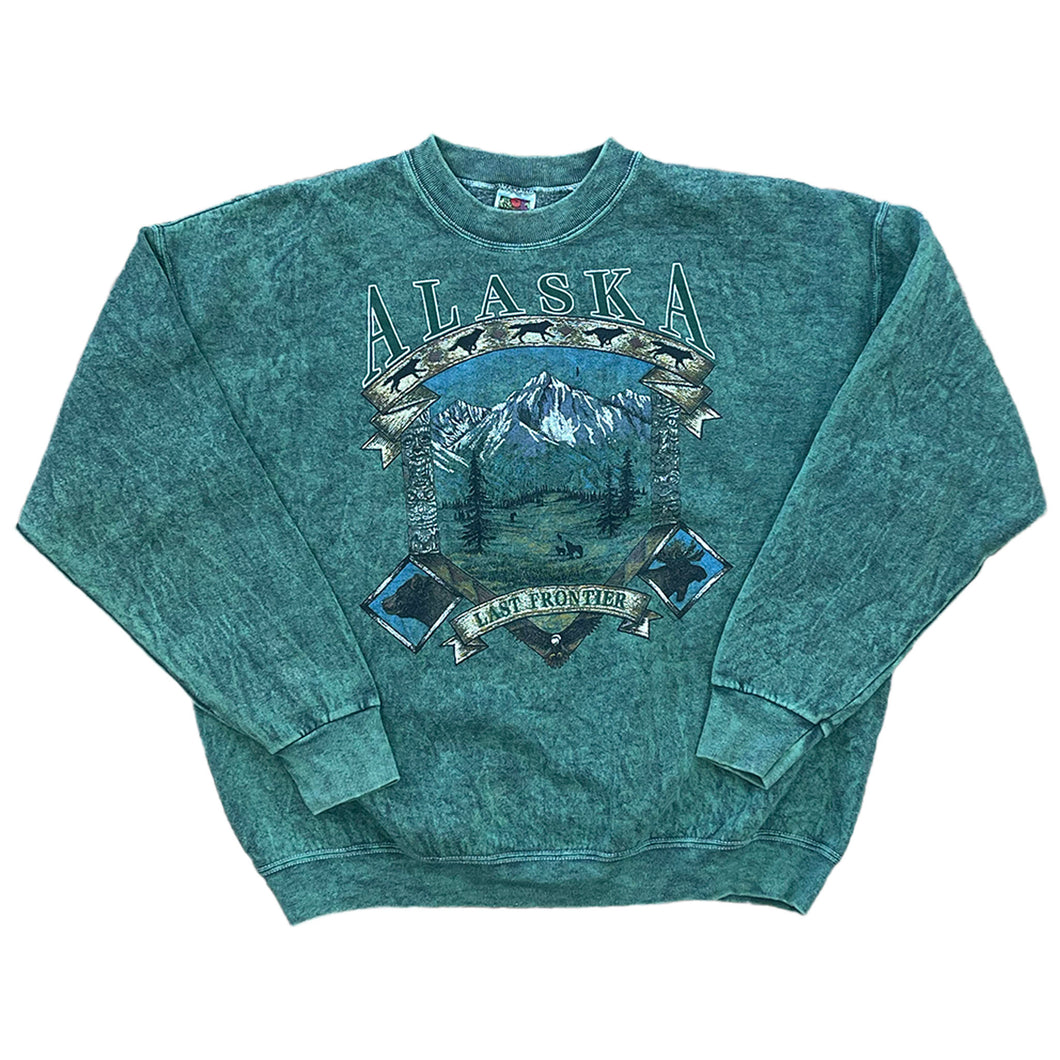 green dyed pullover with ALASKA written on the front with a mountain scenery and last frontier on a banner. 