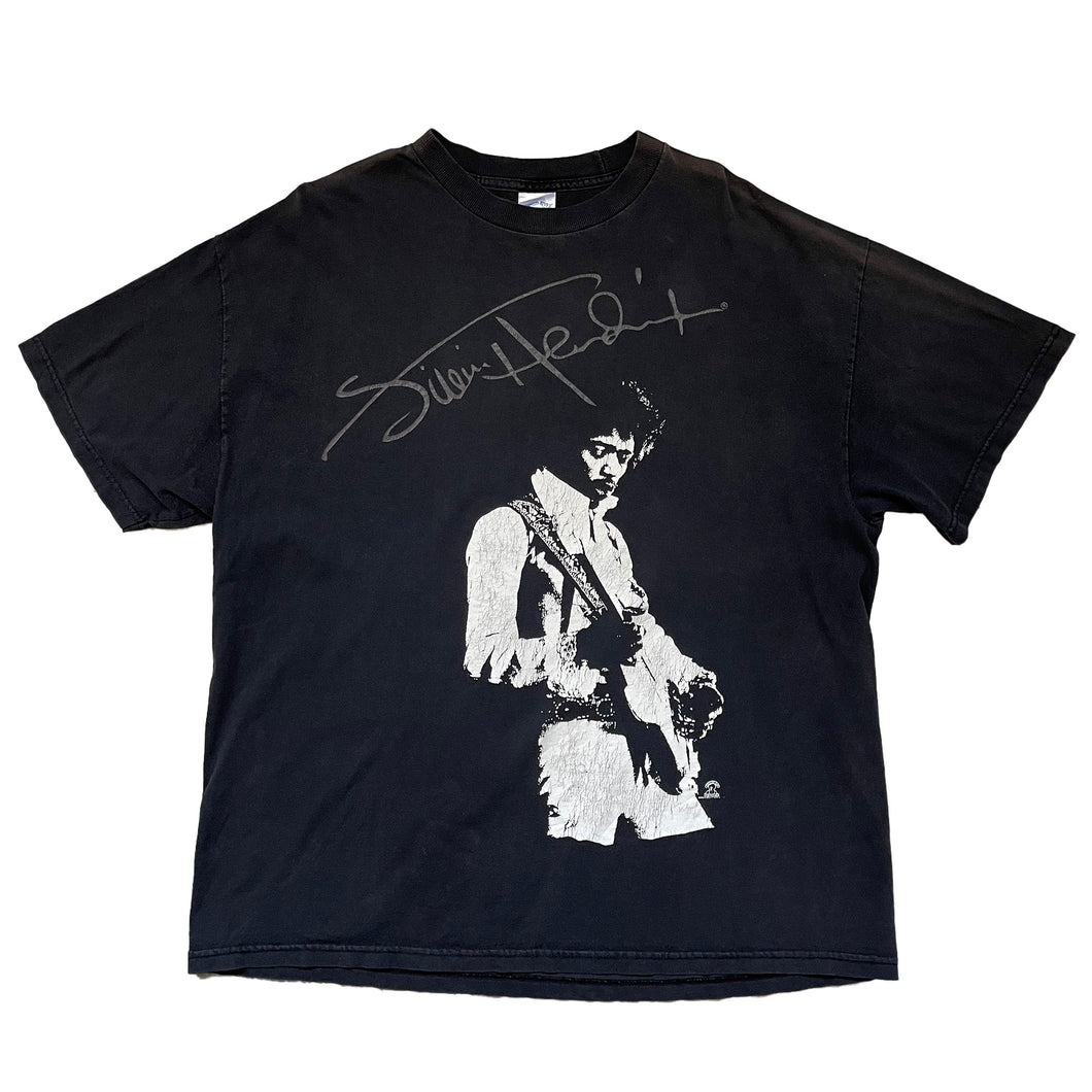 black shirt. print of jimi hendrix signature in grey across the chest with a print of jimi hendrix playing his guitar in white. sun damage on the left shoulder