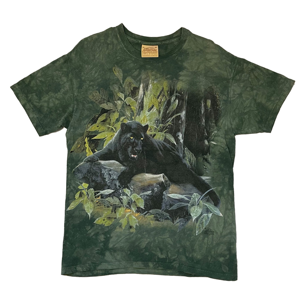 short sleeve shirt. green tie dye with black panther laying on a log with green leaves around.