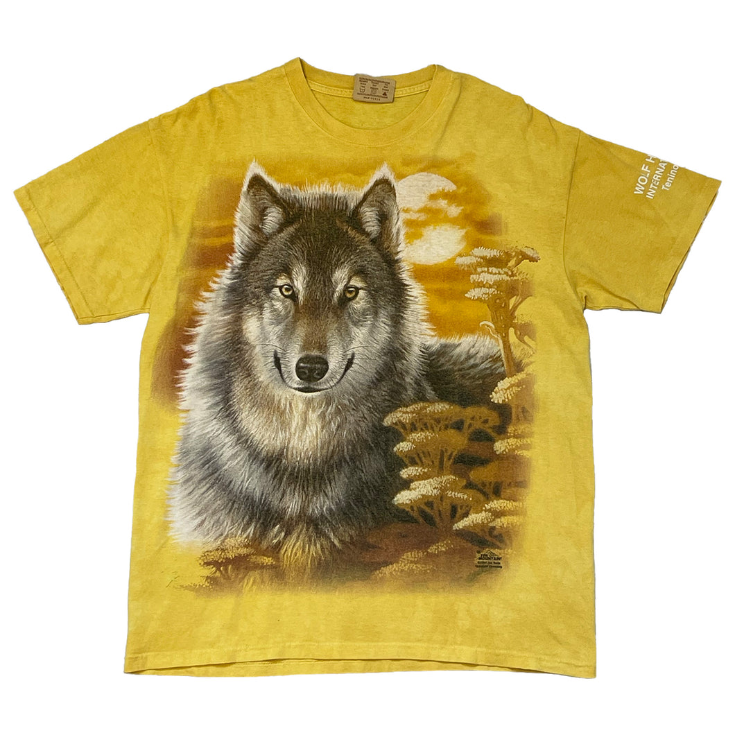 short sleeve shirt. yellow shirt with a wolf on the front and the moon with clouds in the back. wolf international terminal printed on the left sleeve